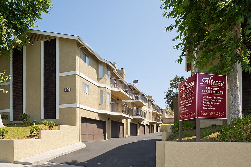 a row of apartments with a sign in front of them